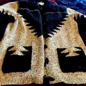 Black and white sweater made with cotton, leather bone buttons and acrylic.